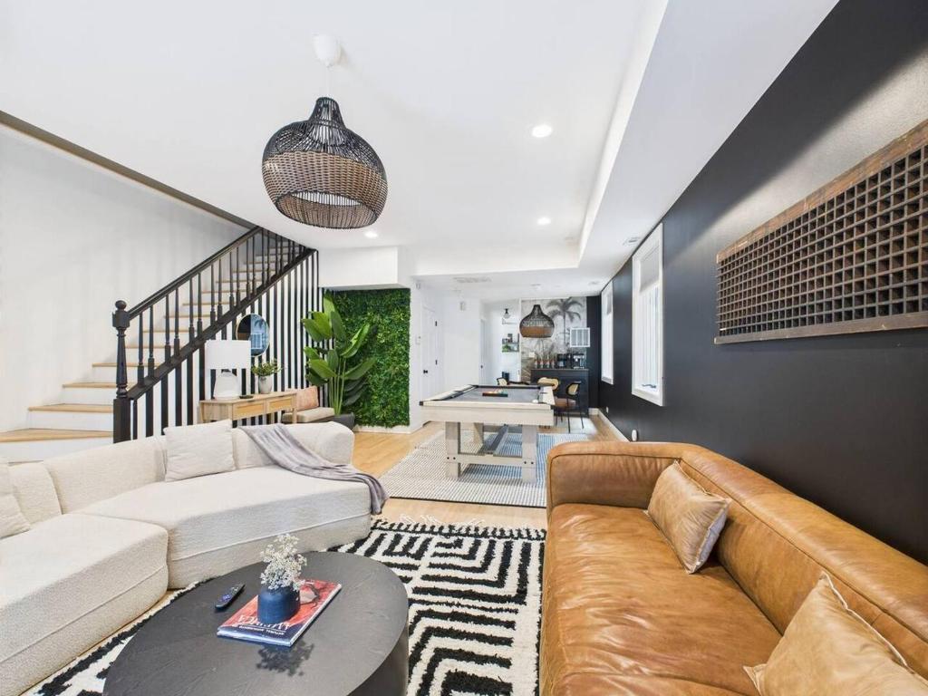 a living room with a couch and a table at Luxe Chicago Retreat Game Room, Deck Fire Pit in Chicago