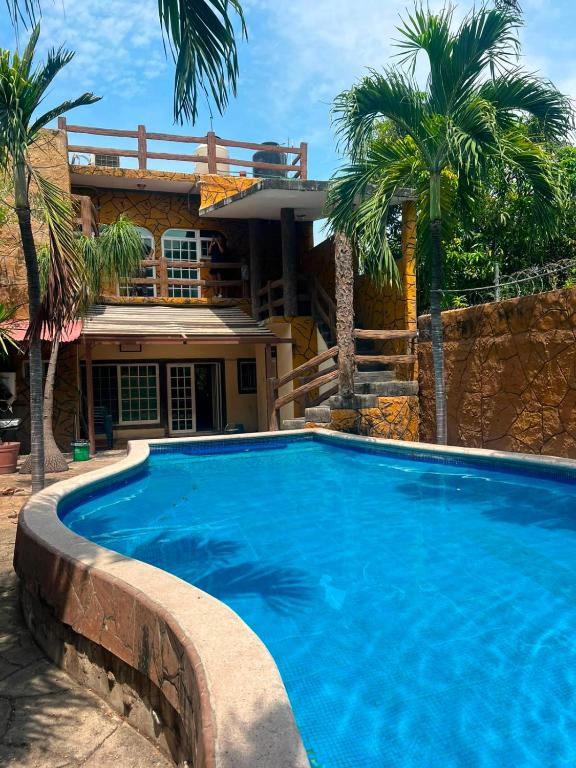 a large swimming pool in front of a house at Las Brisas House, Manzanillo in Manzanillo