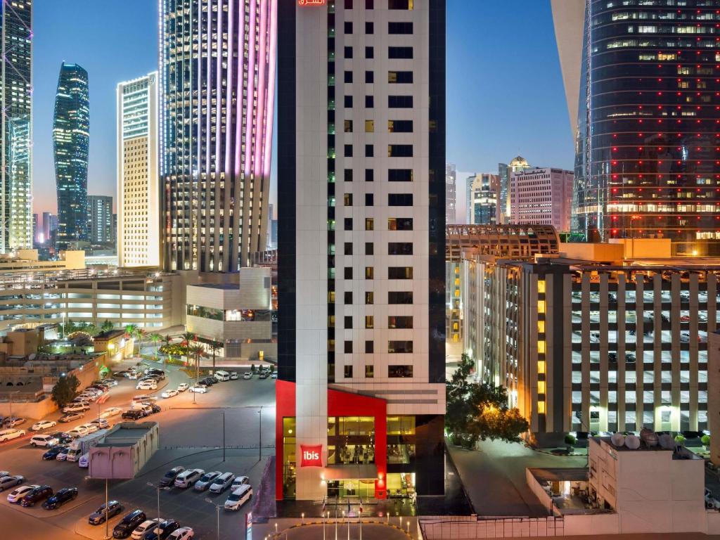 a view of a city skyline at night at ibis Sharq in Kuwait