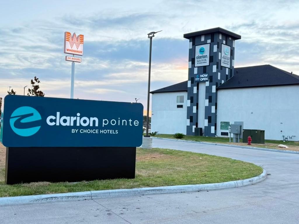 a sign in front of a building next to a building at Clarion Pointe Port Lavaca in Port Lavaca
