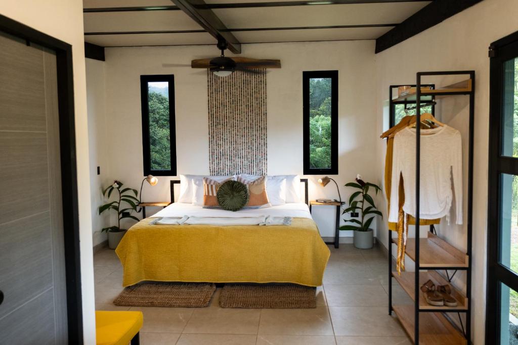 a bedroom with a bed with a yellow blanket at Somni Hill in Torio