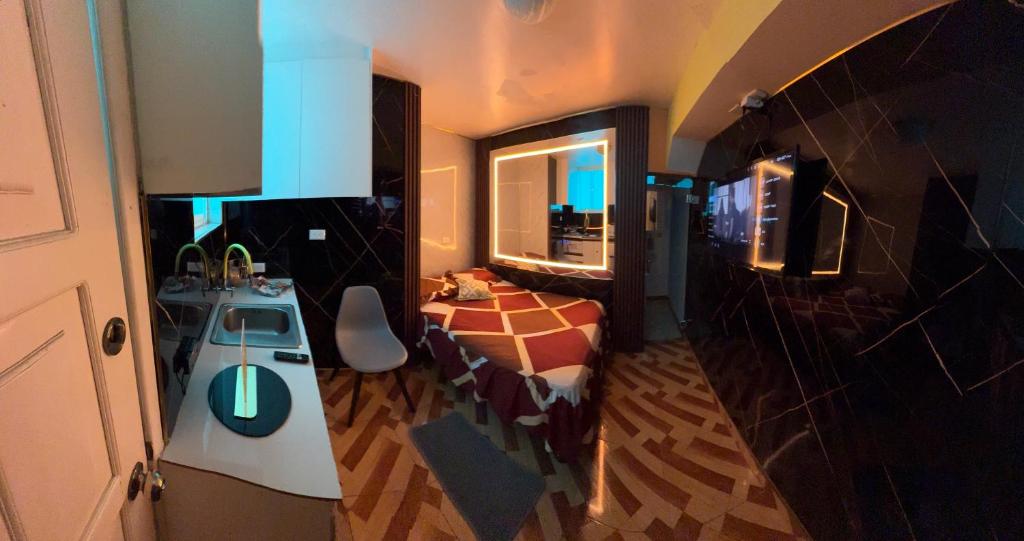 a small room with a bed and a sink in it at Gold House Premium in Quito