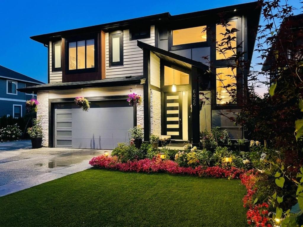 a house with a lot of flowers in front of it at Fairway Retreat Chilliwack in Chilliwack