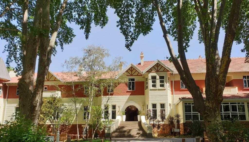 a large house with a red roof at Holiday Inn - Johannesburg Sunnyside Park by IHG in Johannesburg