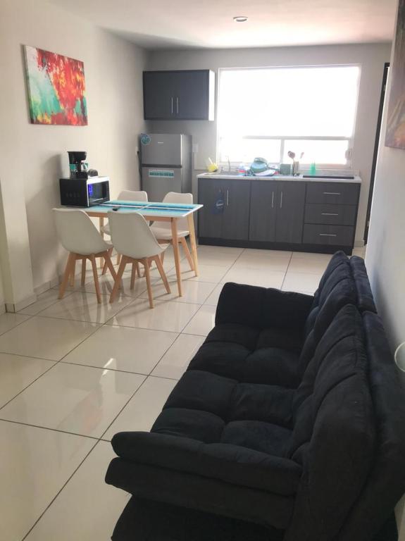 a living room with a couch and a table at Beautiful Executive Apartment 1 in Guadalupe