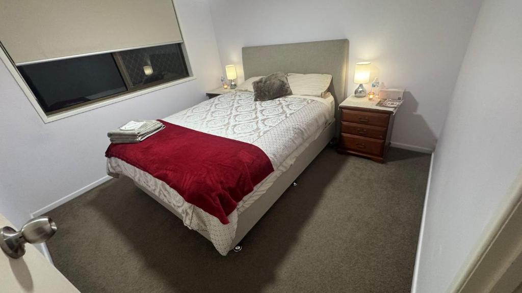 a bedroom with a bed with a cat laying on it at Cozy Quiet Beach room R2 in Brighton