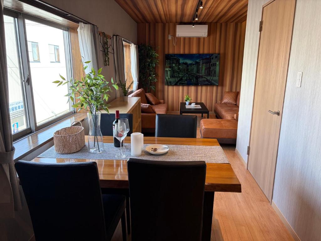 a dining room with a table and a living room at OZ Fuji in Fujiyoshida
