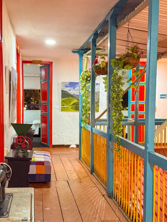 a room with a colorful wall with plants on it at Hotel Casa Rosario in Circasia
