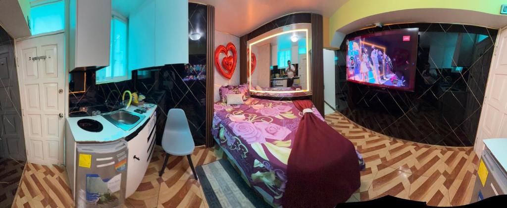 a bathroom with a sink and a tv in a room at Gold House Premium in Quito