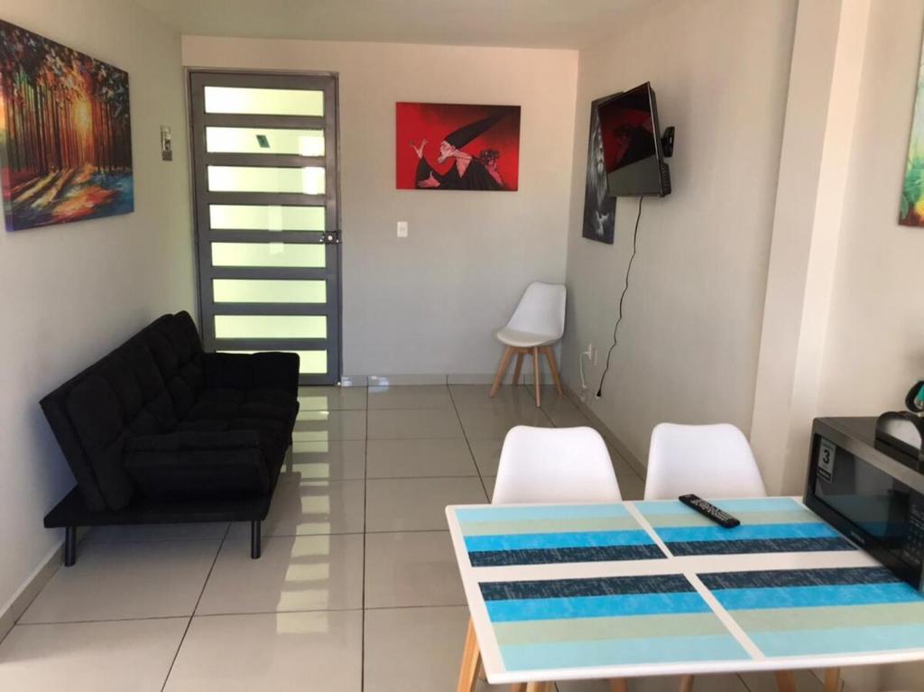 a living room with a couch and a table and chairs at Beautiful Apartment Executive 3 in Guadalupe