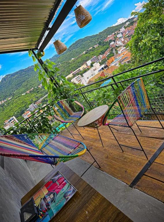 a group of chairs sitting on top of a porch at Hotel Boutique Urban in San Gil