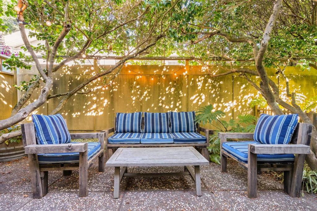 a patio with two chairs and a table and two benches at Design-Forward | Steps to Shops & Dining | 2 Kings in Mill Valley