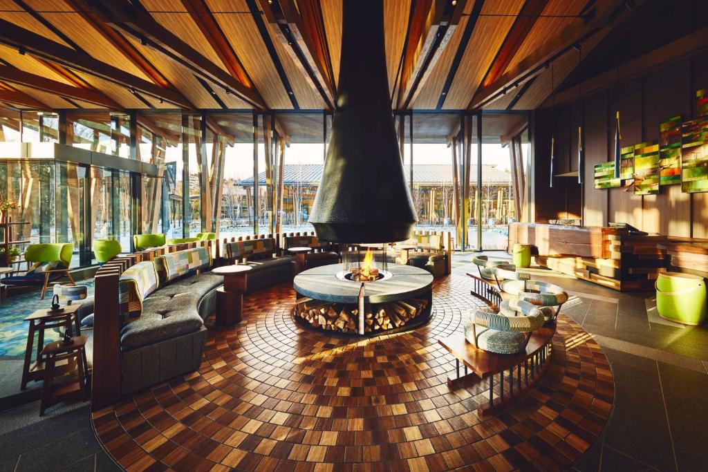 a lobby with couches and a table in a building at Hotel Indigo Karuizawa by IHG in Karuizawa