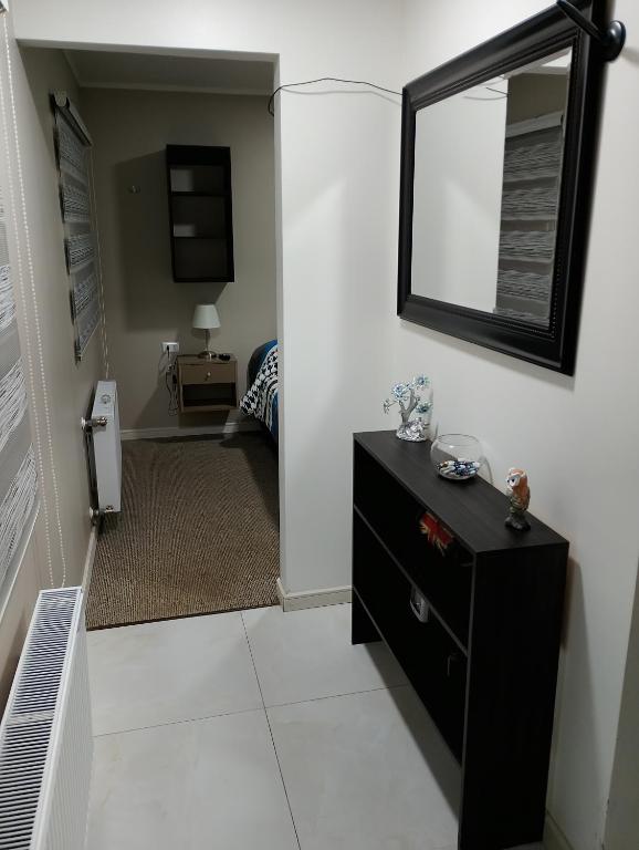 a bathroom with a black dresser and a mirror at cabañas los flamencos A in Punta Arenas