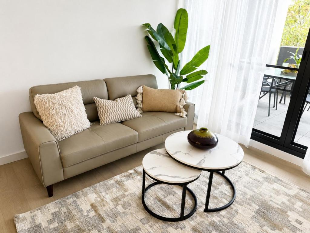 a living room with a couch and a table at Contemporary 2BR Stay in Campbell