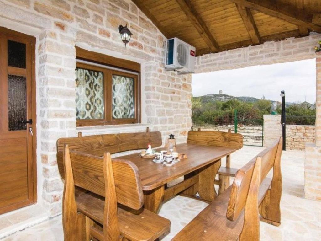 a dining room with a wooden table and chairs at Three bedroom Vila with Pool in Stankovci