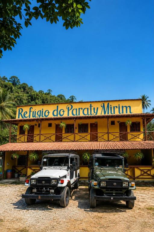 two trucks parked in front of a hotel at Refúgio do Paraty Mirim in Paraty