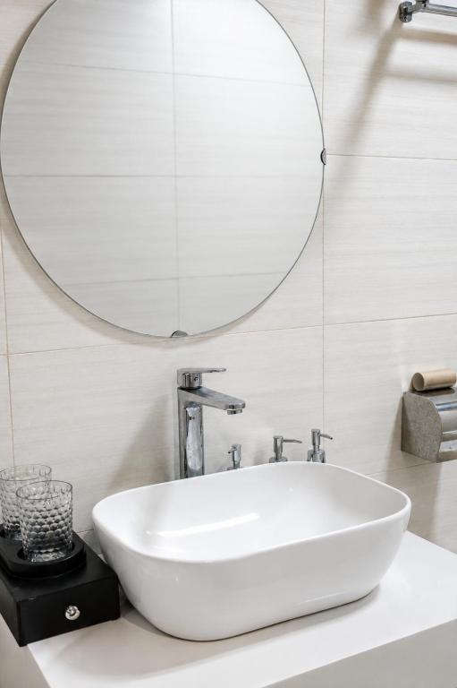 a white sink in a bathroom with a mirror at Minh chau riverside in Quang Ninh