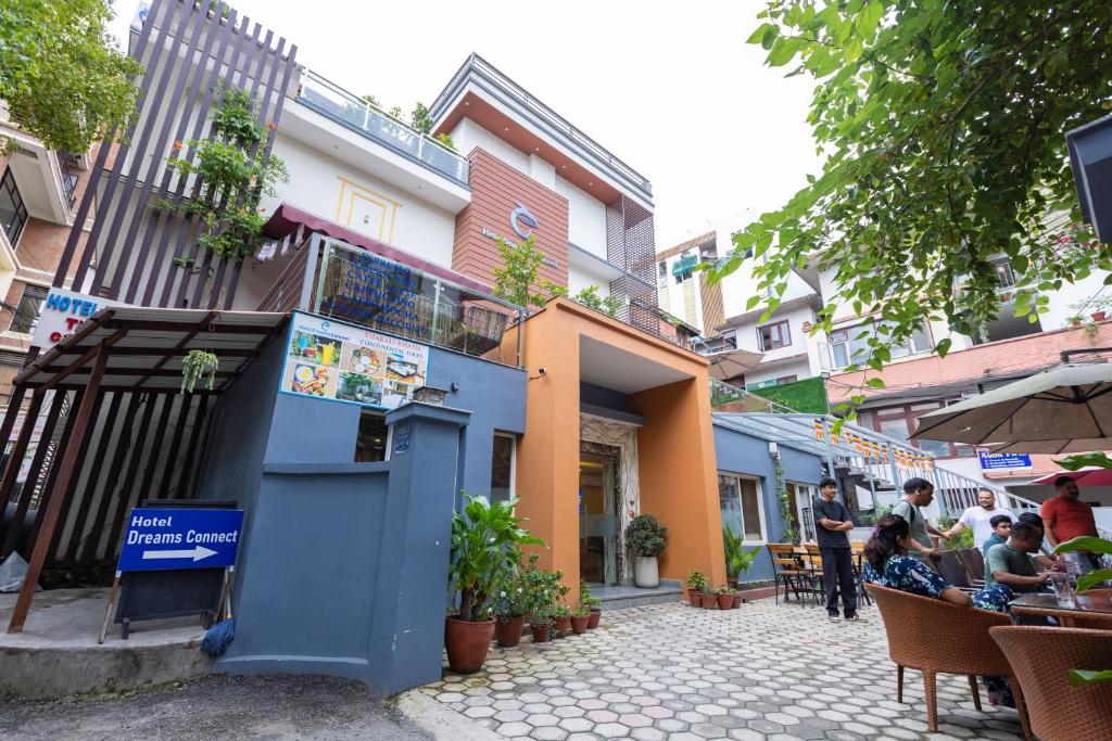 a group of people sitting at tables outside a building at Hotel Dreams Connect GRB 2 in Kathmandu