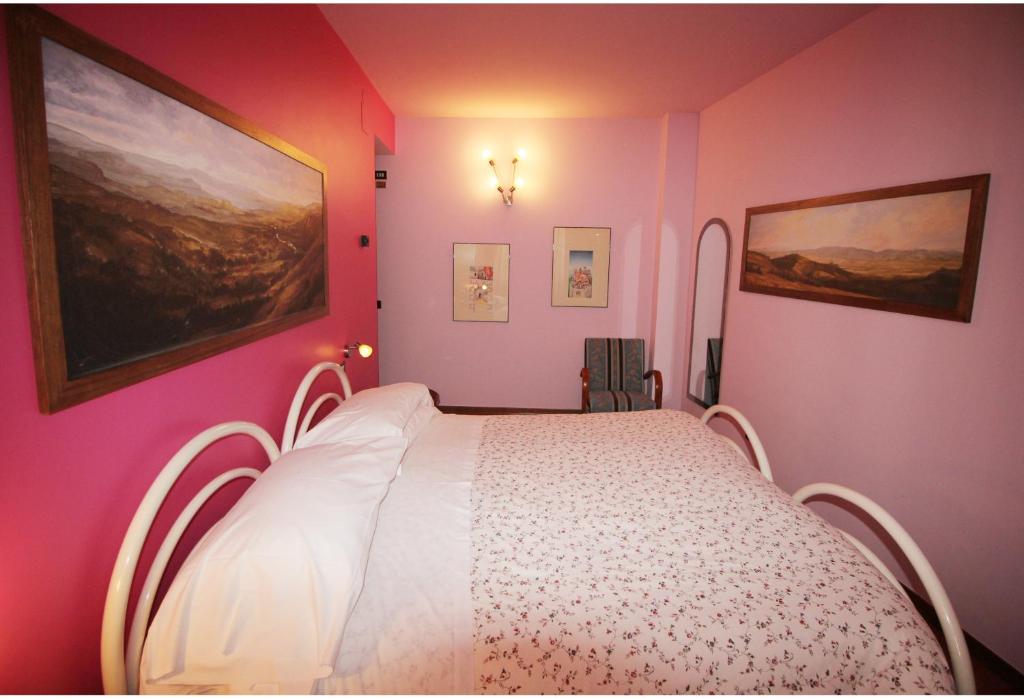 Postel nebo postele na pokoji v ubytování Hotel Pallotta