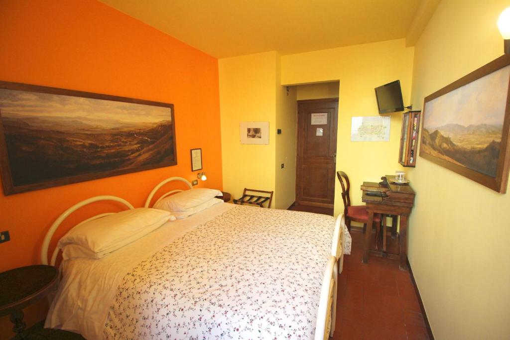 Postel nebo postele na pokoji v ubytování Hotel Pallotta