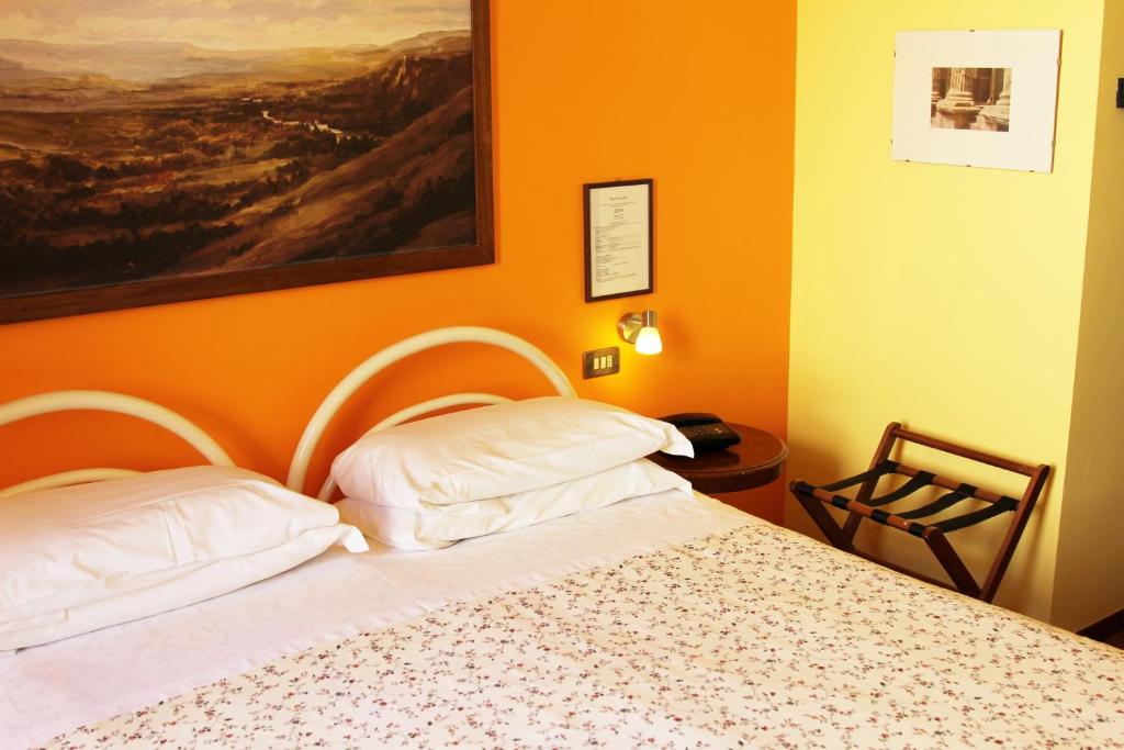 Postel nebo postele na pokoji v ubytování Hotel Pallotta