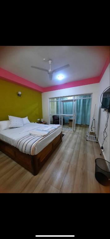 a bedroom with a large bed in a room at Gelephu city hotel in Geylegphug