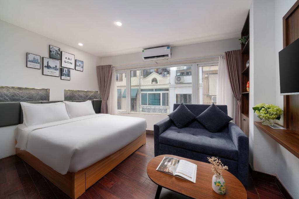 a hotel room with a bed and a couch at TRUNG - The Coffee House in Hanoi