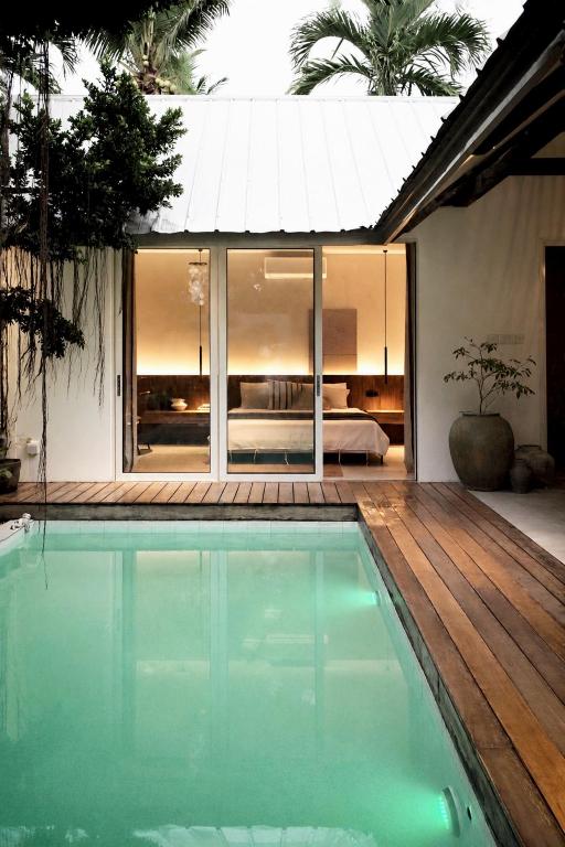 a swimming pool in front of a house at Banyan Villa Panglao with private pool in Panglao Island