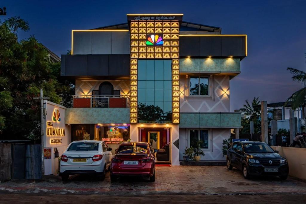 a building with cars parked in front of it at SREE Kumaran Residence in Rāmeswaram
