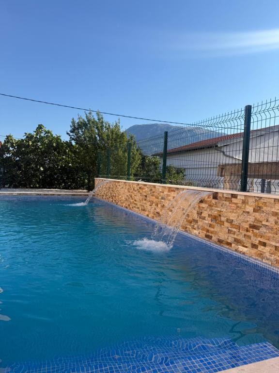 a water fountain in a swimming pool at ZIS LUX Apartments Pool in Utjeha