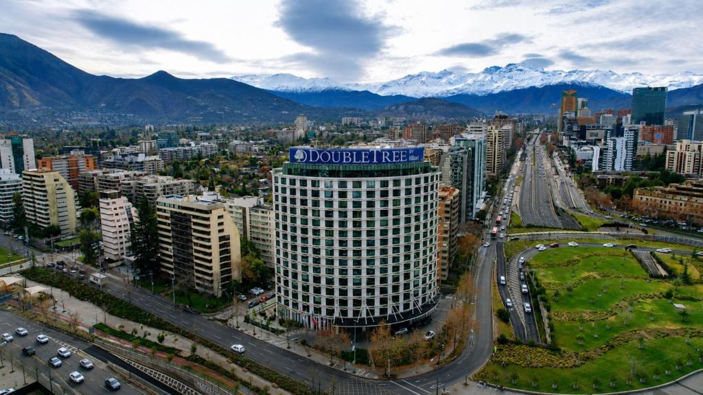 a large building with a blue sign on top of it at DoubleTree by Hilton Santiago Kennedy, Chile in Santiago