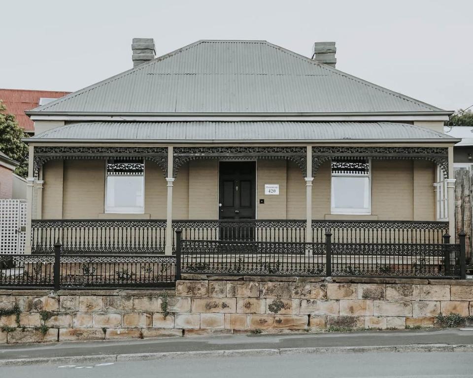 a house with a fence in front of it at Little Elizabeth in West Hobart