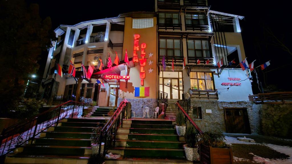 a group of flags on the steps of a building at Hotel Perla Oltului in Caciulata