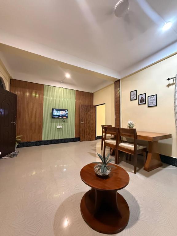 a lobby with a desk and a table and a bench at Nirvana homes in North Lakhimpur