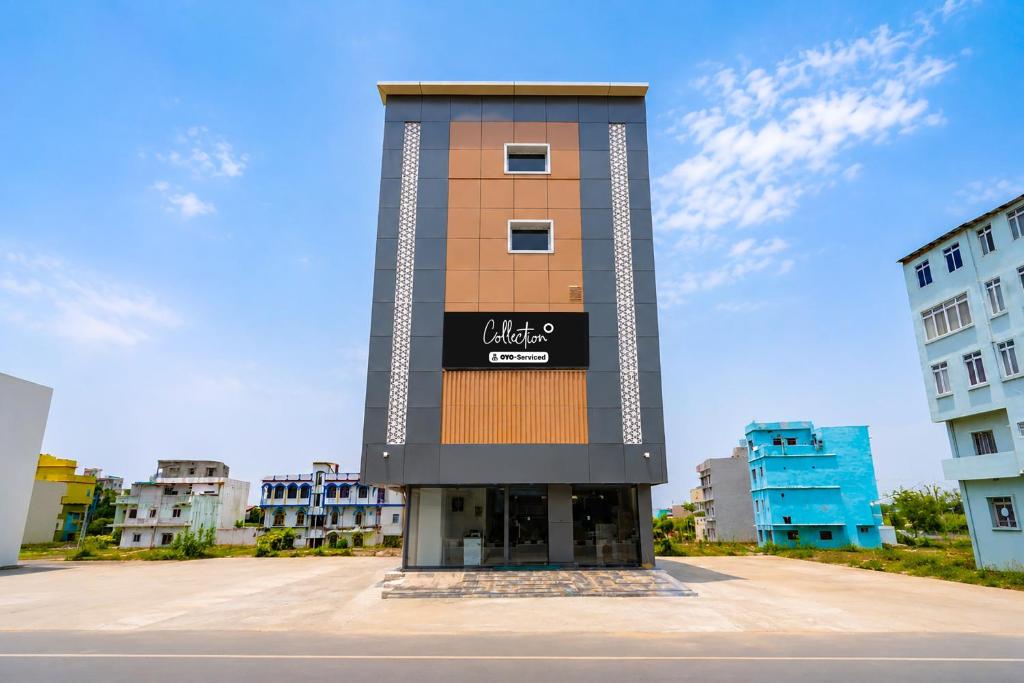 a tall building with a sign on top of it at Collection O Rajgir Railway Station Formerly Hotel Swastik in Ekangar Sarai