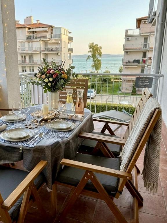 a table and chairs with a view of the ocean at Balaton BeachSide Apartman Siófok N2 in Siófok