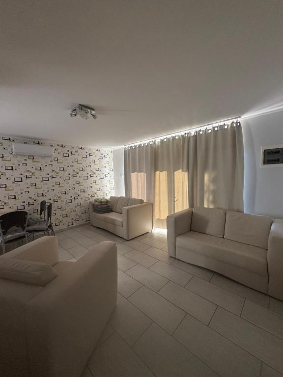 a living room with two couches and a table at Babzsi Nyaraló in Vonyarcvashegy