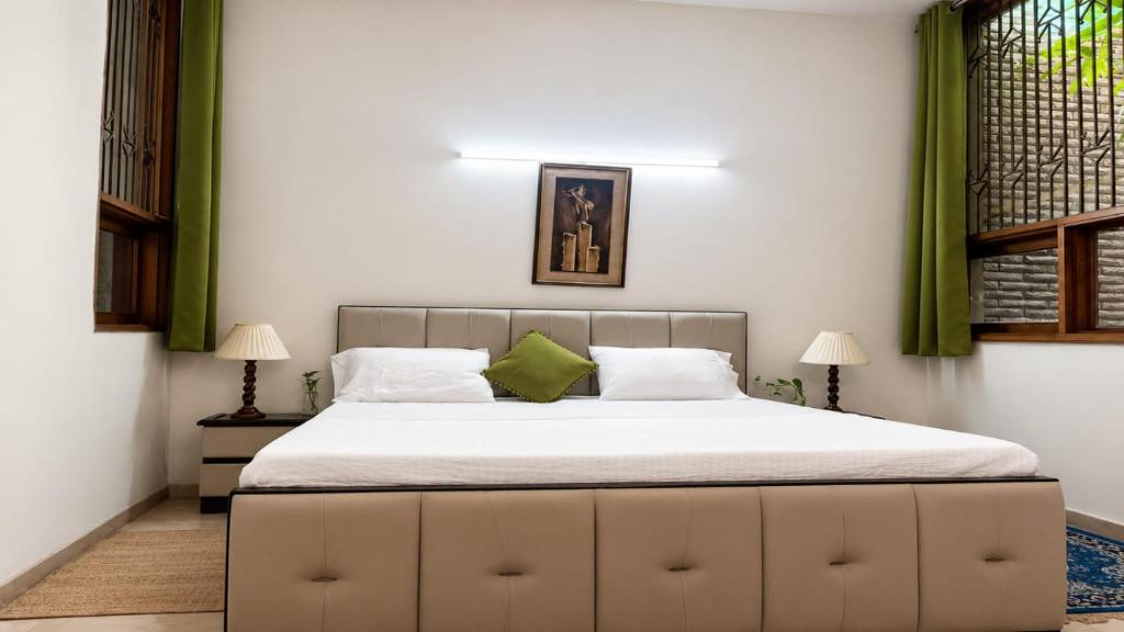 a bedroom with a large bed with green curtains at Dr Balis Bliss Homestay in New Delhi