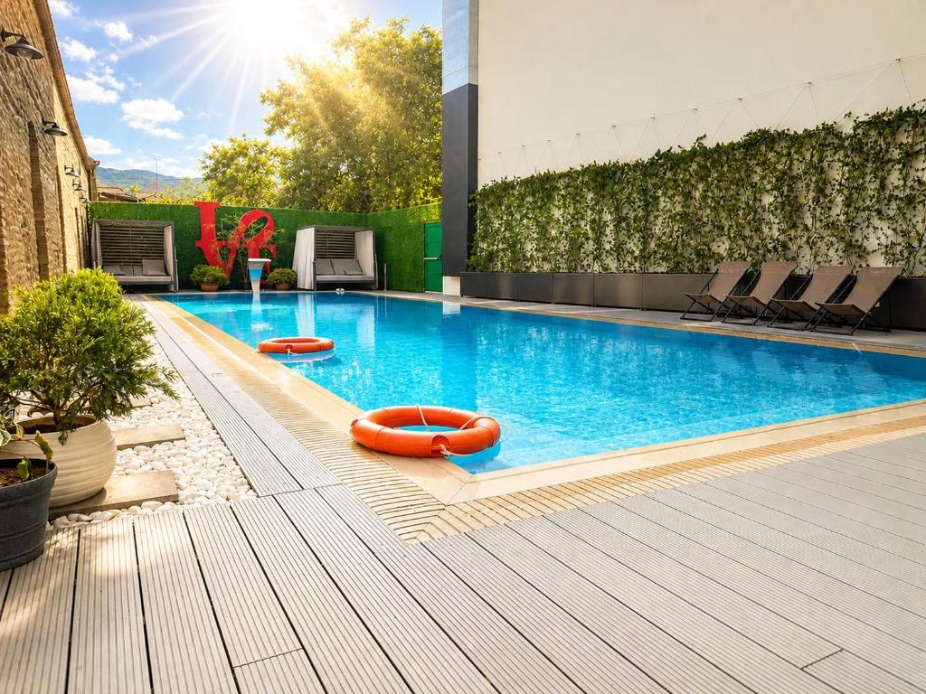a swimming pool with orange inflatables on a building at Holiday Inn Telavi by IHG in Telavi