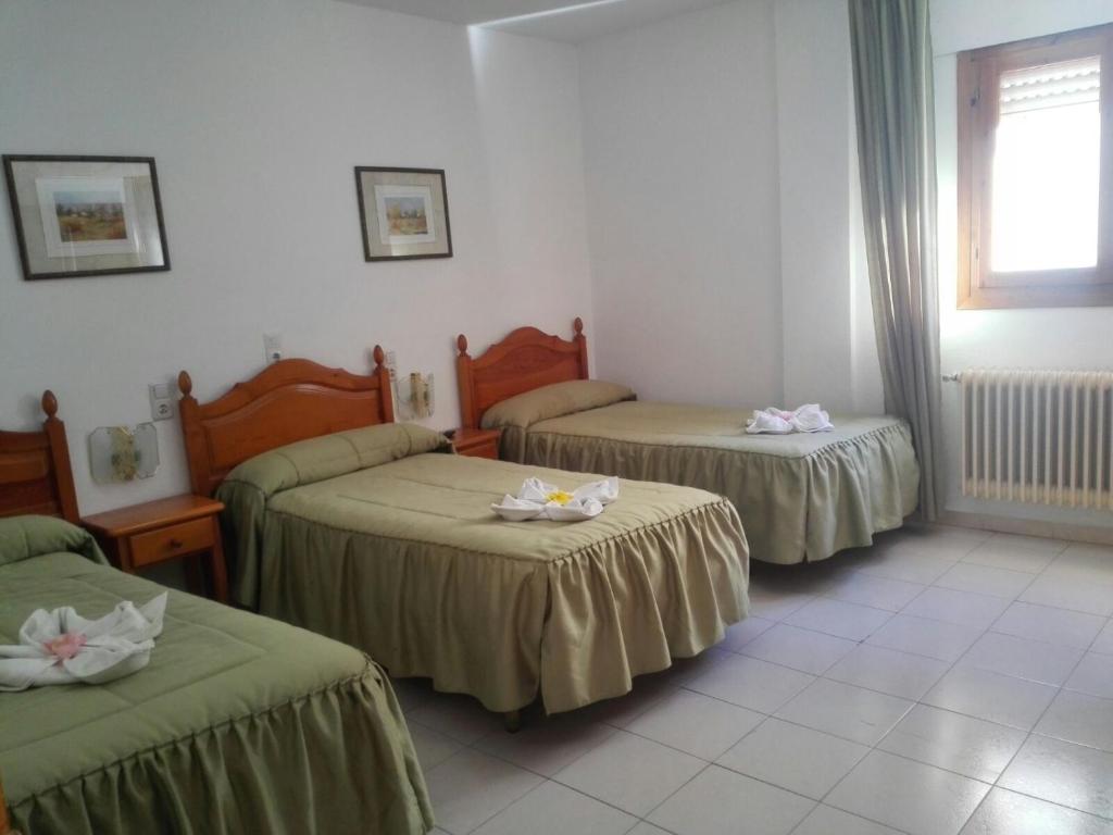 Cama o camas de una habitación en Hostal Mulhacen