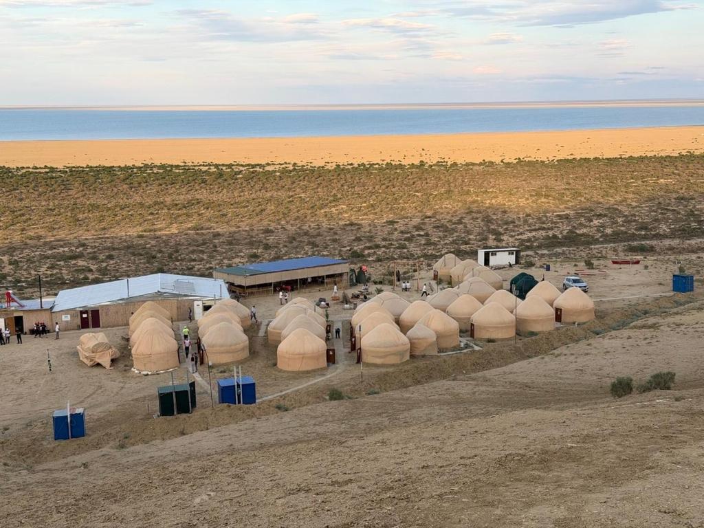 an overhead view of a group of domes on the beach at Besqala Yurt Camp in Kabanbay