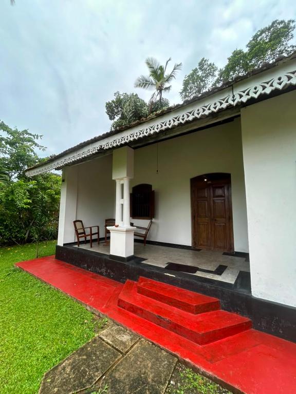 a house with a red carpet in front of it at La Olive Villa 