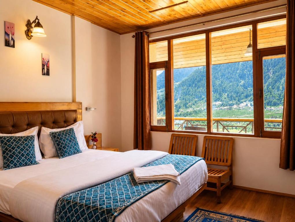 a bedroom with a bed and a large window at Lime Tree Haven in Kulu