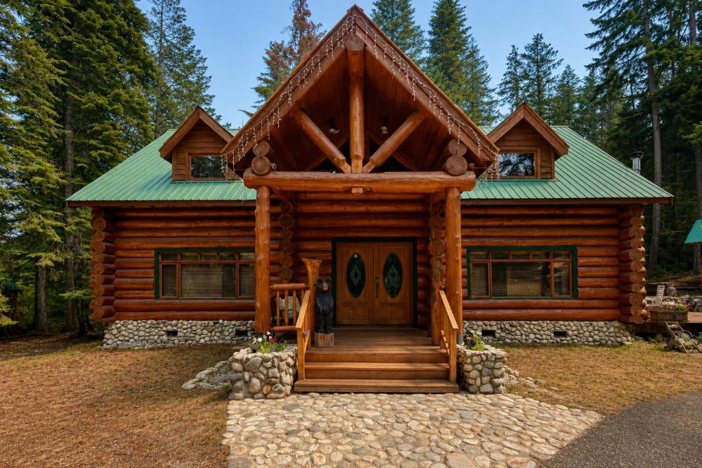 a log cabin with a green roof at Soaring Pines Lodge by NW Comfy Cabins in Leavenworth