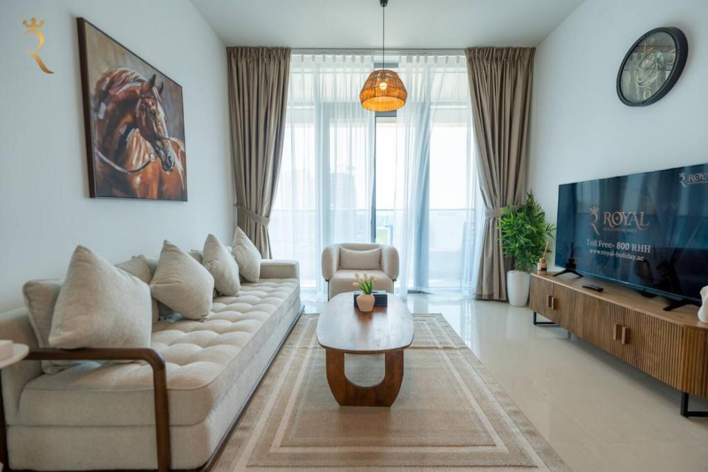 a living room with a couch and a table at Pearl 1BR Al Reem - Serene Luxe Escape in Abu Dhabi