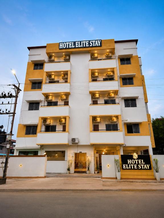 a hotel building with a sign that reads hotel staff stay at Hotel Elite Stay in Bori