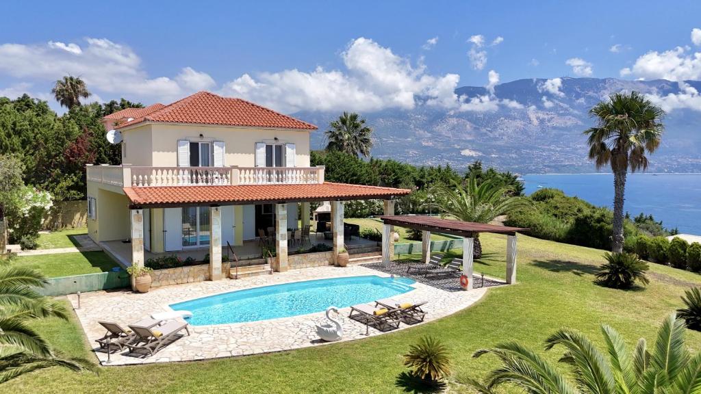 a villa with a swimming pool and a house at Villa Dimitra in Trapezaki