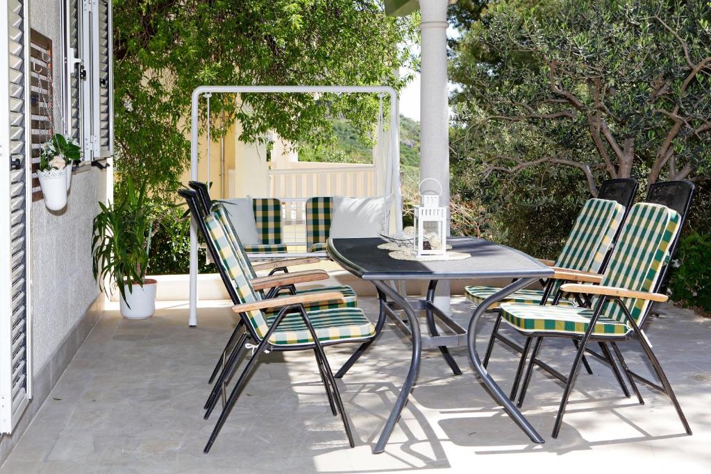 a black table and chairs on a patio at Apartments Villa Adria Bol in Bol