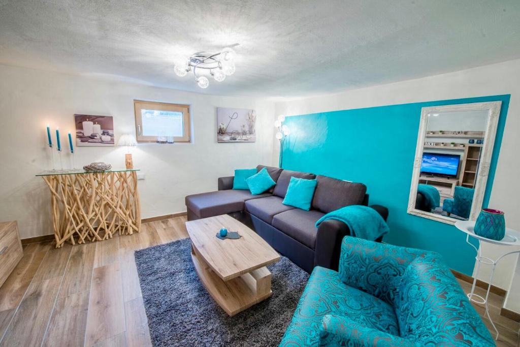 a living room with a couch and a table at Ferienwohnung Wald in Wald im Pinzgau